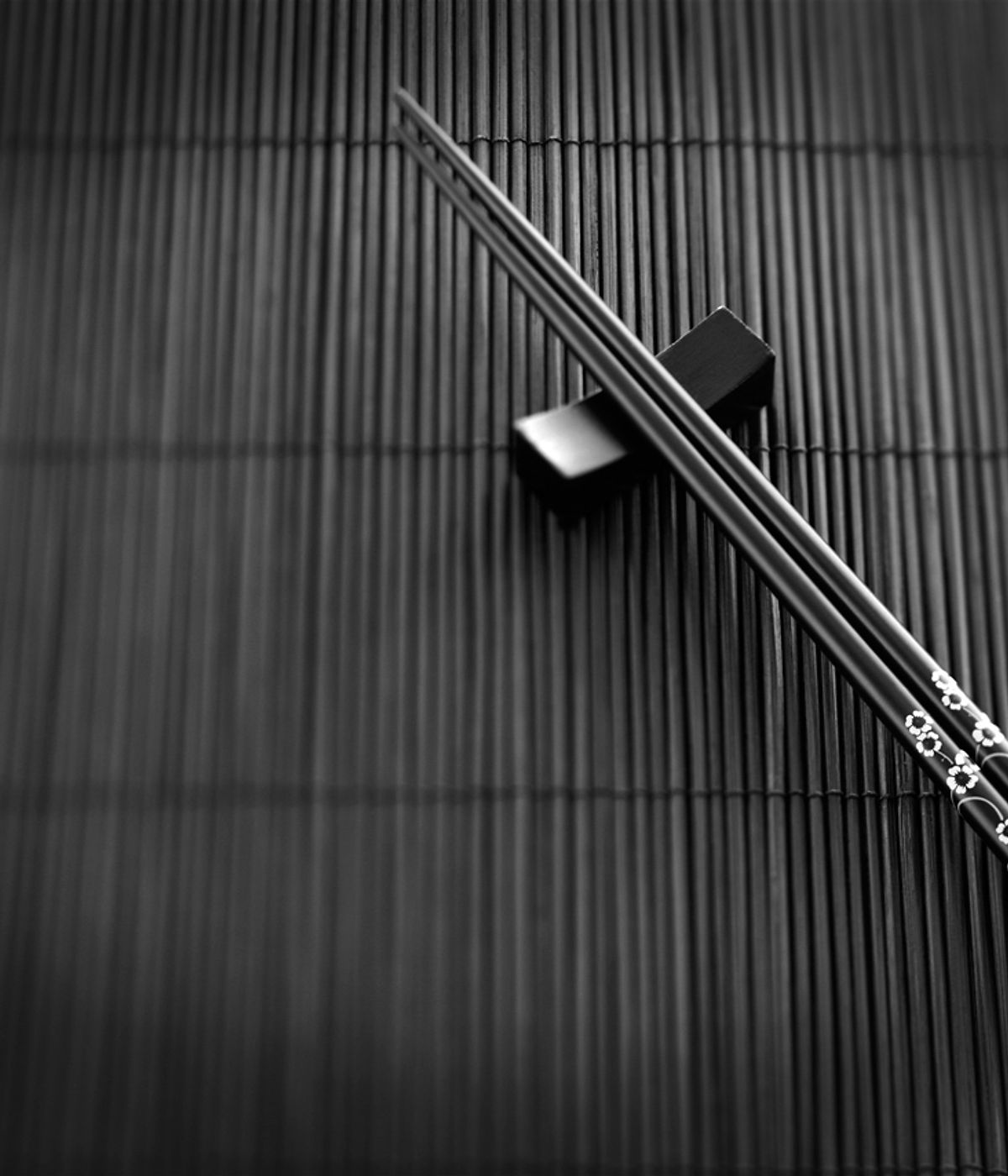 Chopsticks resting on a bamboo mat